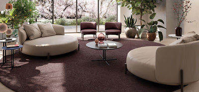 Living room with two leather cream love Natuzzi Amalia love seats and two smaller burgundy arm chairs