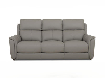 Grey leather sofa with high sectional back on a white background